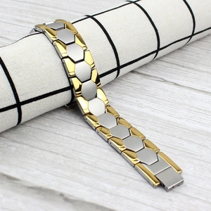 Close-up of gold and silver men titanium steel bracelet with hexagonal link details