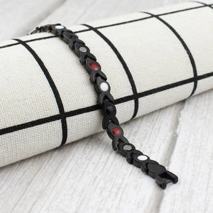 Women's black titanium steel magnetic bracelet with gold accents and colorful inlays