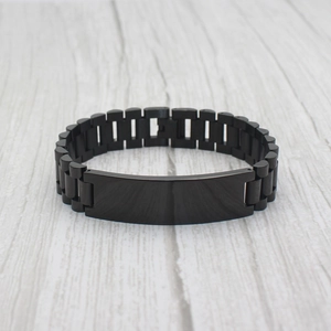 Men's matte black watch-style chain bracelet with a blank rectangular ID plate for engraving