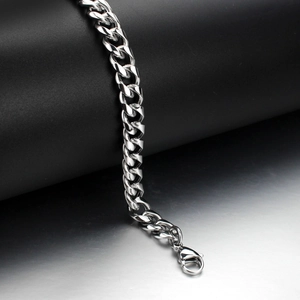 Polished silver stainless steel Cuban link bracelet with lobster clasp on display