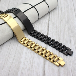 Sleek gold and matte black stainless steel watch band style ID bracelets on plaid fabric