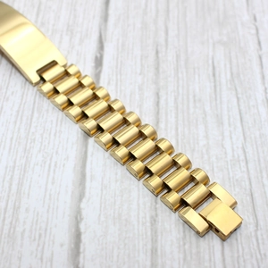 Detailed view of golden stainless steel watch band with classic triple link design