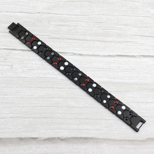 Bracelet de magnétothérapie en acier inoxydable noir pour homme sur fond en bois