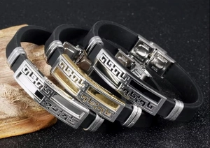 Detail of stainless steel clasp and Greek meander pattern on black silicone bracelet