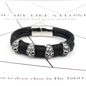 Men's punk braided leather bracelet with silver skull charms and magnetic clasp