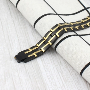 Men's two-tone magnetic therapy bracelet in black and gold stainless steel link design