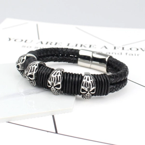 Men's punk braided leather bracelet with silver skull charms and magnetic clasp