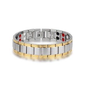 Macro detail of men's wide stainless steel bracelet showing inner magnets and gold trim