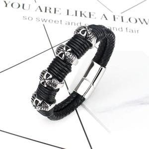Punk men's braided leather bracelet with silver skull charms and magnetic clasp