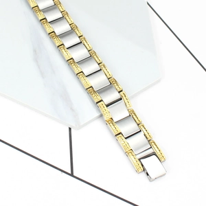 Detail of two-tone stainless steel link bracelet with gold textured edges and silver links