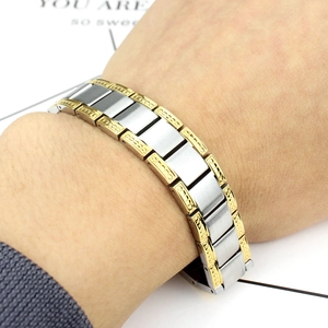 Detail of masculine two-tone stainless steel magnetic bracelet with brushed silver links