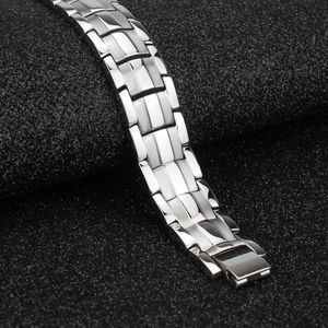 Macro detail of 15mm stainless steel bracelet showing brushed metal finish and folding clasp