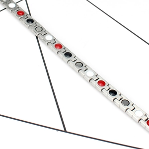 Detail eines magnetischen Silberarmbands mit bunten Steineinlagen in mechanischen Gliedern