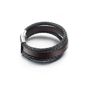 Detail of multi-layer leather bracelet with black braided cords and brown flat strap