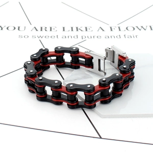 Macro shot of industrial red and black stainless steel bicycle chain bracelet with clasp