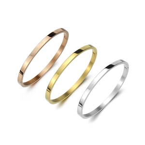 Detailed view of polished gold, silver, and rose gold stainless steel oval bangles