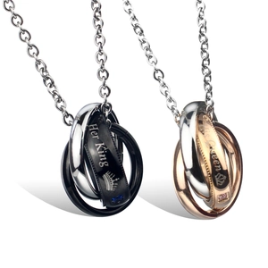Close-up of Her King His Queen interlocking rings necklaces with zircon stones