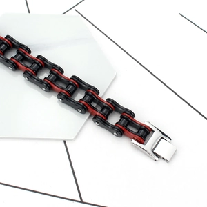 Industrial style red and black stainless steel bike chain bracelet on a white stone base