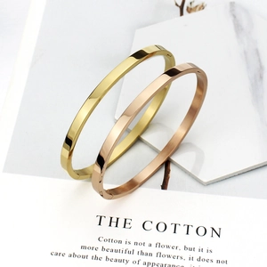 Polished stainless steel oval bangle bracelets in gold and rose gold finishes