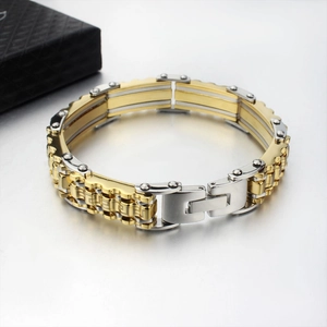 Detail of two-tone stainless steel men's bracelet with Greek meander pattern and folding clasp
