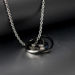 Detail of Her King pendant with crown engraving and blue gemstone on steel chain