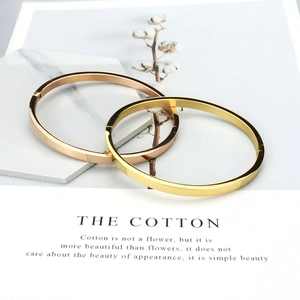 Minimalist polished stainless steel oval bangles in gold and rose gold finishes
