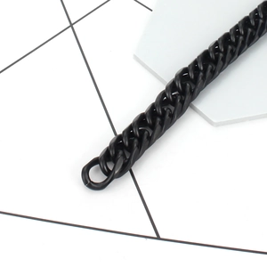 Close-up of matte black stainless steel Cuban link bracelet with flat oval chain links