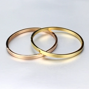 Polished titanium steel bangles in gold and rose gold with a minimalist flat edge design