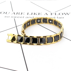 Macro detail of men's stainless steel ceramic bracelet with magnetic therapy inserts