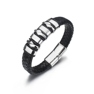 Detail of black woven leather strap and polished steel metal ornaments on men's bracelet