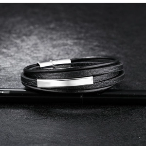 Detailed close-up of multilayer leather bracelet featuring a polished silver metal plate