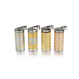 Detail of cylindrical Buddhist pendants in silver, gold, and rose gold with lotus engraving