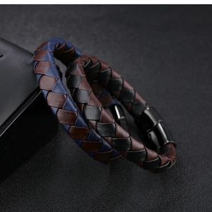 Macro shot of woven leather bracelets with two-tone design and magnetic black clasp