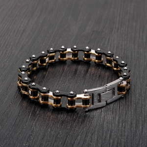 Detail of multi-color motorcycle chain bracelet with rivets on dark wood surface