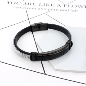 Detail of men's steel mesh bracelet featuring a polished black metal center and buckle