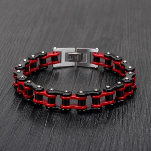 Detailed close-up of a red and black industrial motorcycle chain bracelet in stainless steel