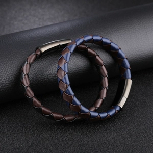 Men's braided cowhide leather bracelet with magnetic metal clasp on black background