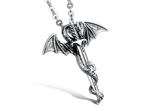 Detailed view of an oxidized silver dragon pendant wrapped around a sword on an O-link chain