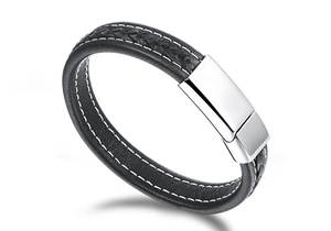 Detail of black woven leather strap and polished silver buckle on men's punk bracelet