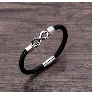 Close-up of black braided leather bracelet with silver infinity symbol and magnetic clasp