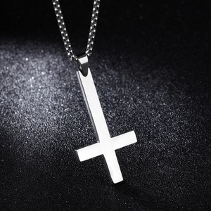 Polished stainless steel upside down cross pendant with bead chain on black background