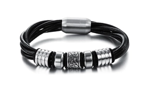 Detail of men's multilayer black leather bracelet with engraved steel beads and magnetic clasp