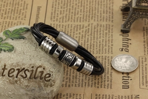 Close-up of men's multi-layer braided leather bracelet with vintage metal beads
