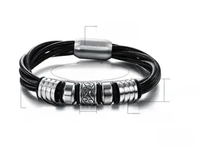 Detail of men's braided leather bracelet featuring vintage steel beads and magnetic clasp