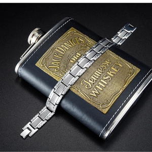 Detailed view of silver stainless steel men's bracelet with textured grid engraving and clasp