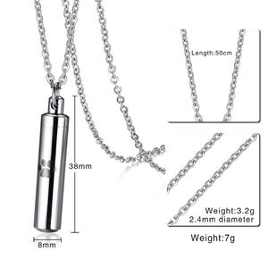 Macro view of cylinder stainless steel cremation urn pendant with laser paw print