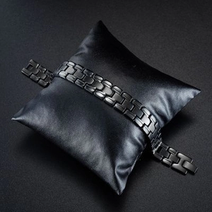 Men's black electroplated stainless steel link bracelet on a black display pillow