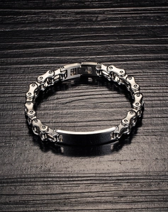 Detail of silver stainless steel motorcycle chain bracelet with matte metal plate