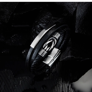 Macro detail of men's leather bracelet with steel magnetic clasp and metal accents