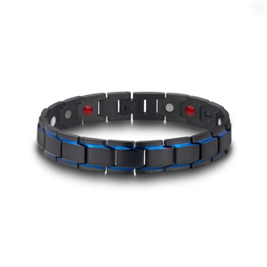 Macro detail of men's magnetic steel bracelet showing blue-black links and energy magnets